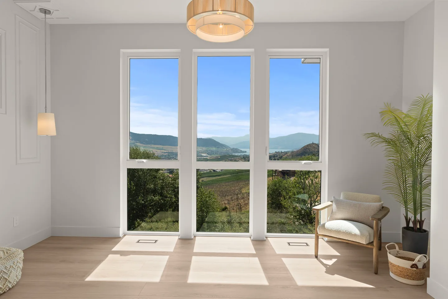 Primary bedroom with tall windows and valley views